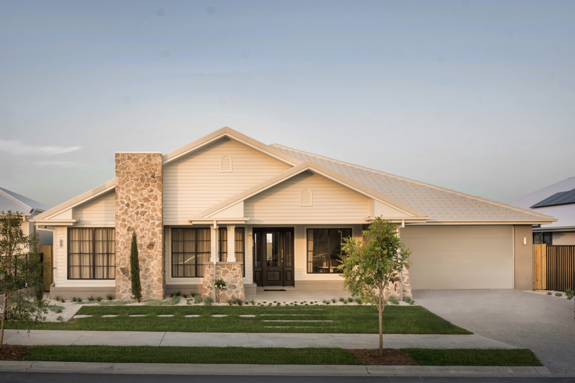 Bold Living single storey home facade with stone feature and timber front door