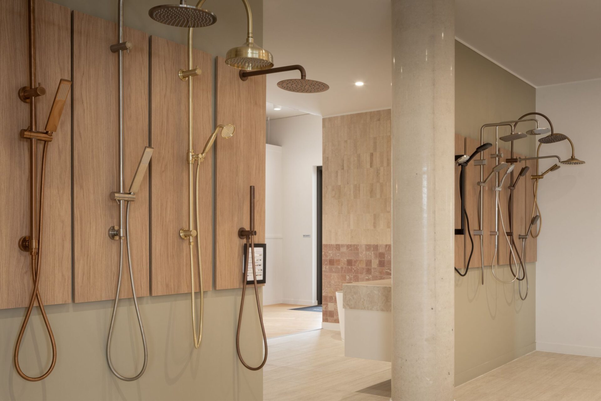 Shower rails and rain heads in brushed brass and copper